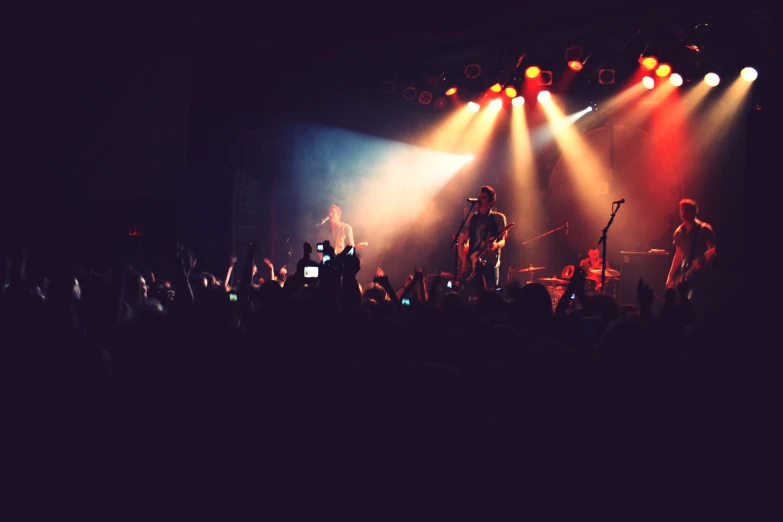 a concert scene with two guitarists on stage