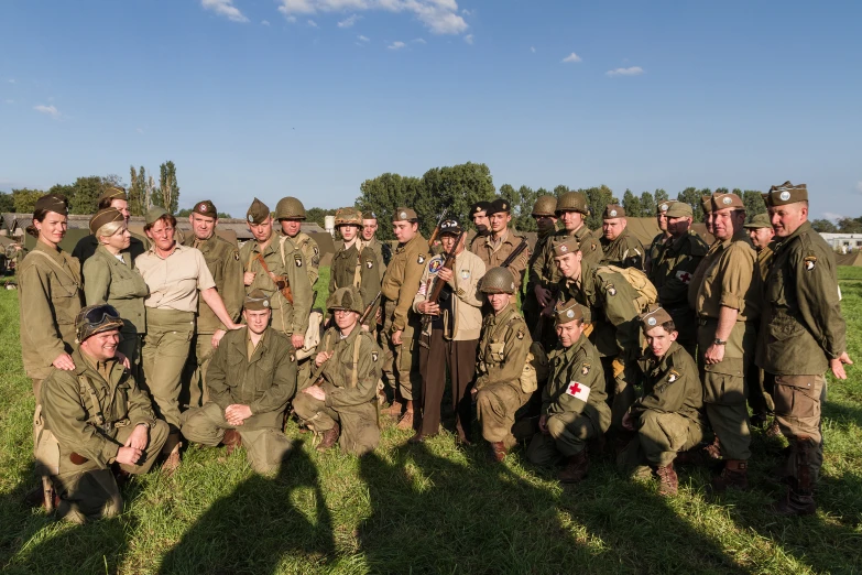 a group of soldiers and civilians posing for a po
