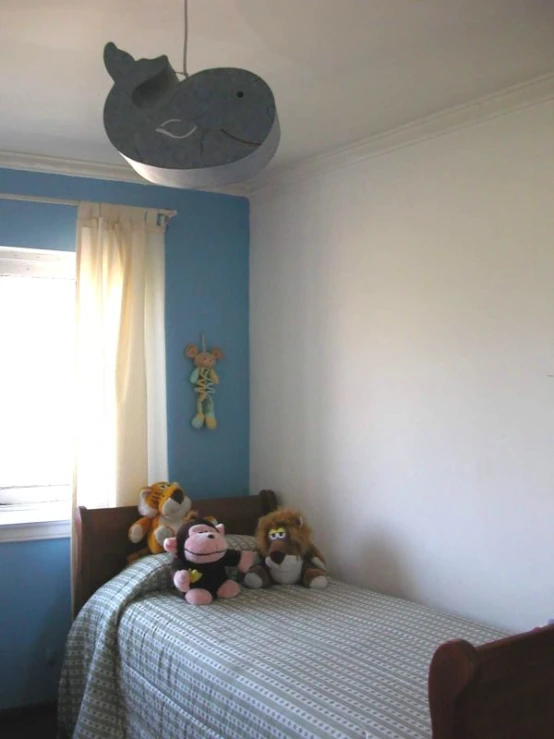 the stuffed animals are on the bed in this bedroom