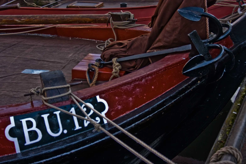 red and black boat docked at a port