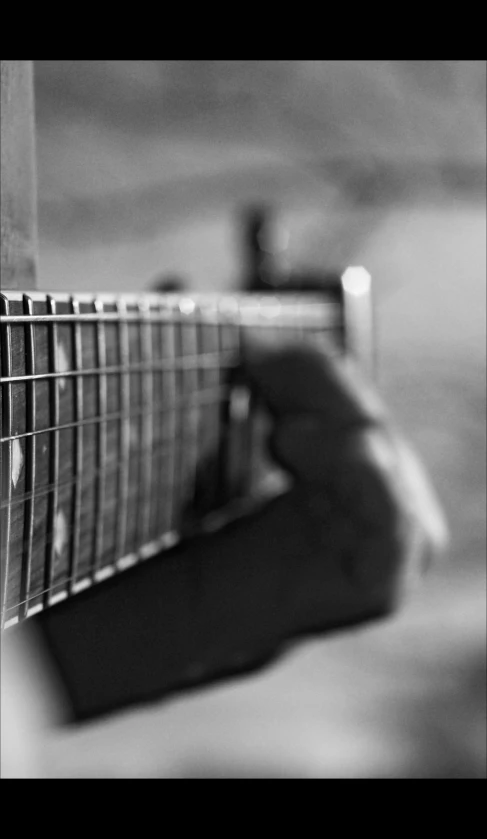 a person's hands playing an acoustic guitar