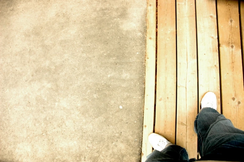 a person on a wooden walkway looking down