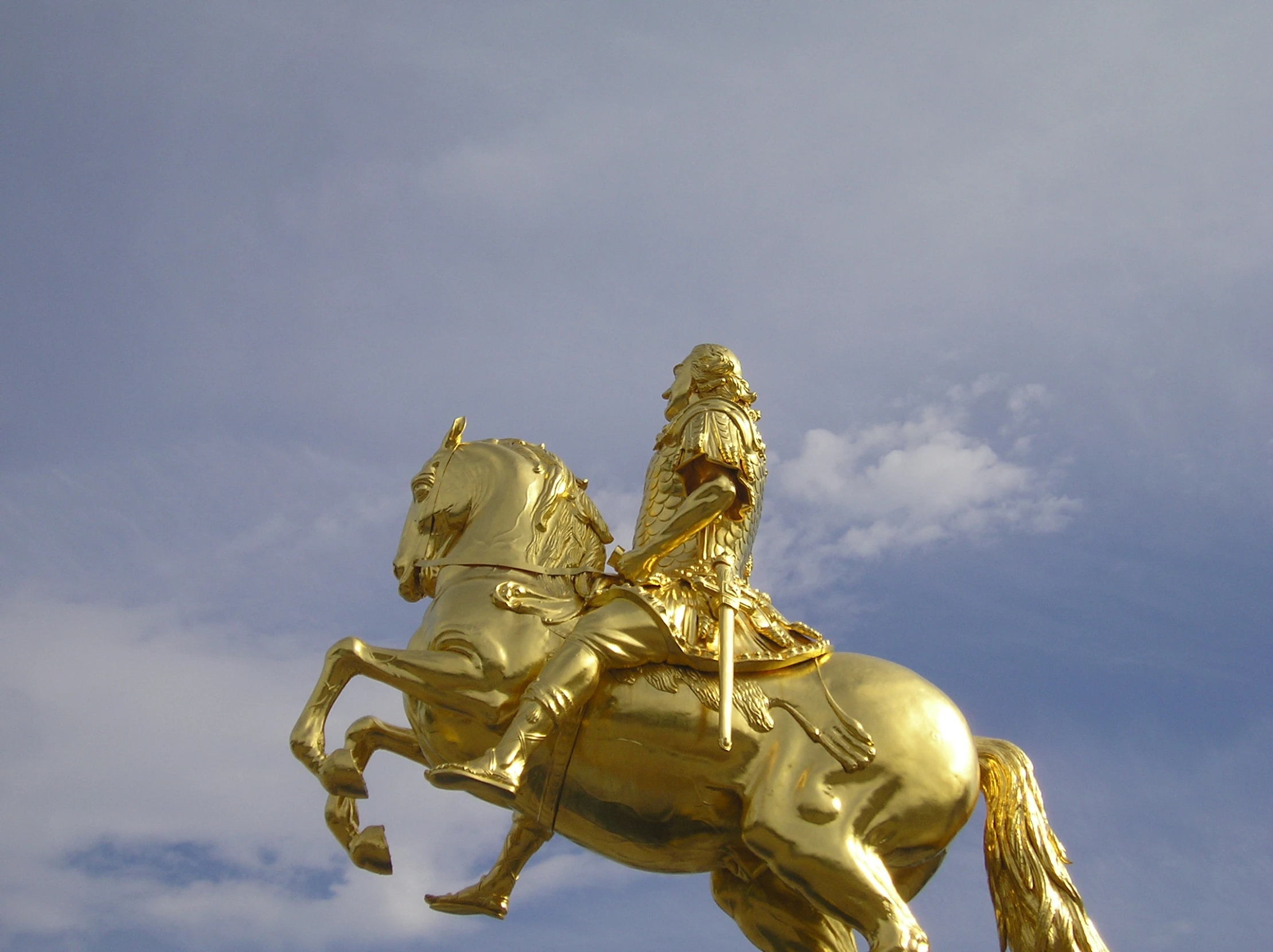 a gold statue of a man on top of a horse