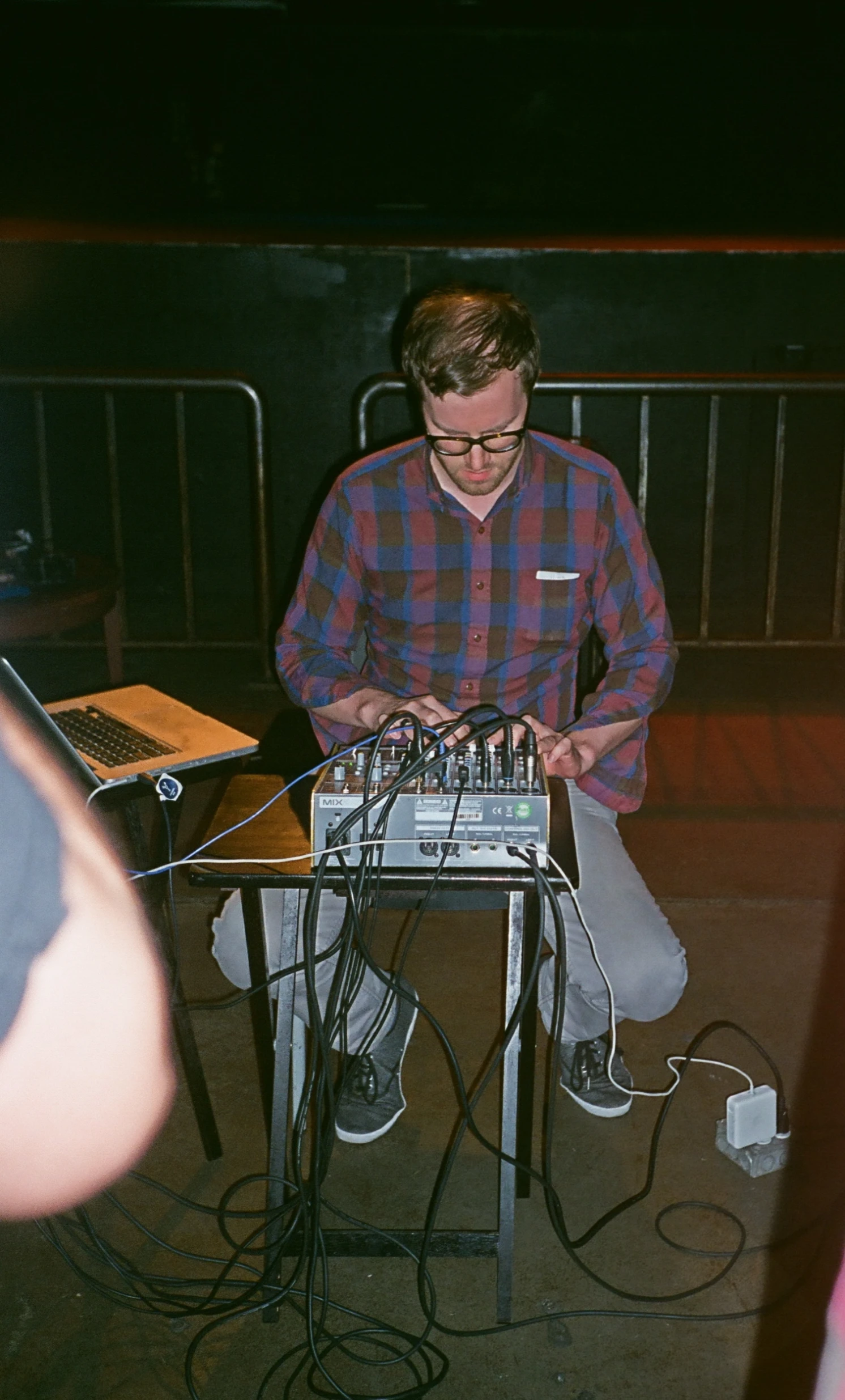 an electronic device sitting in front of a man on a keyboard