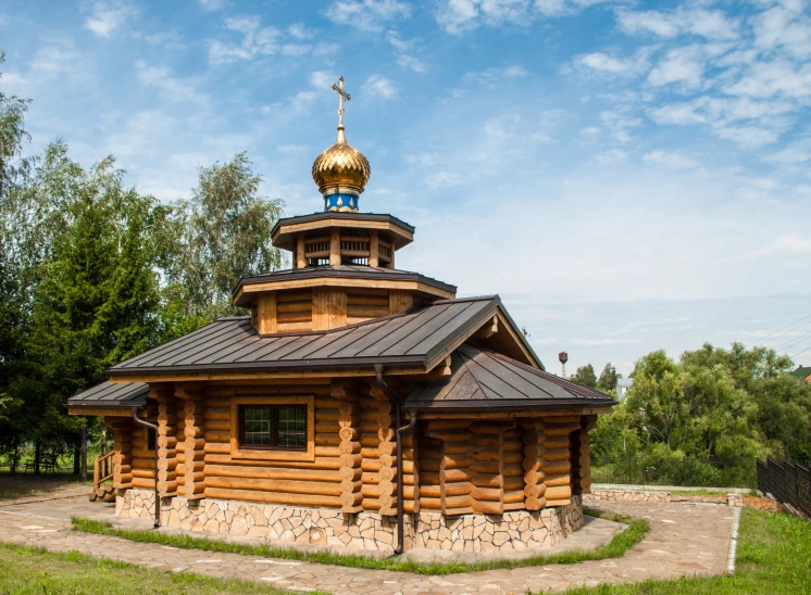 a very nice looking wooden building with a big dome