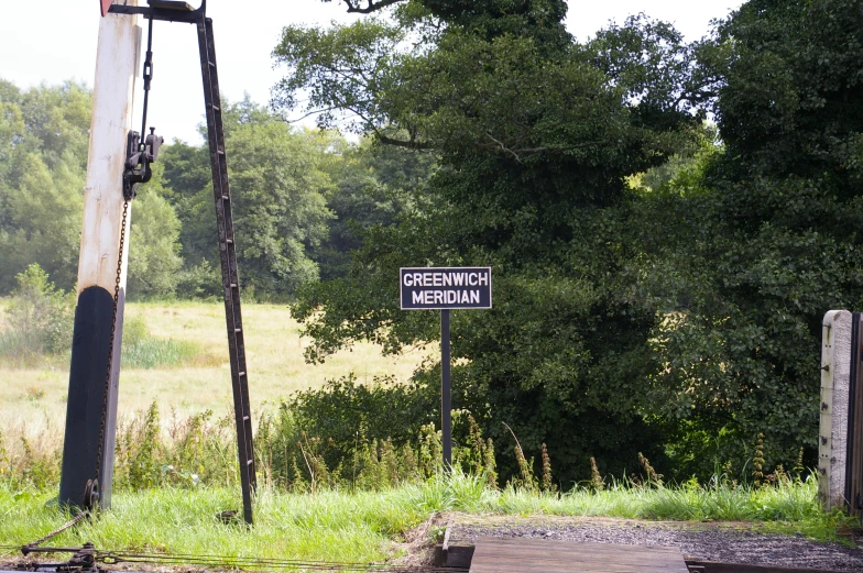 an intersection with a road sign and traffic lights