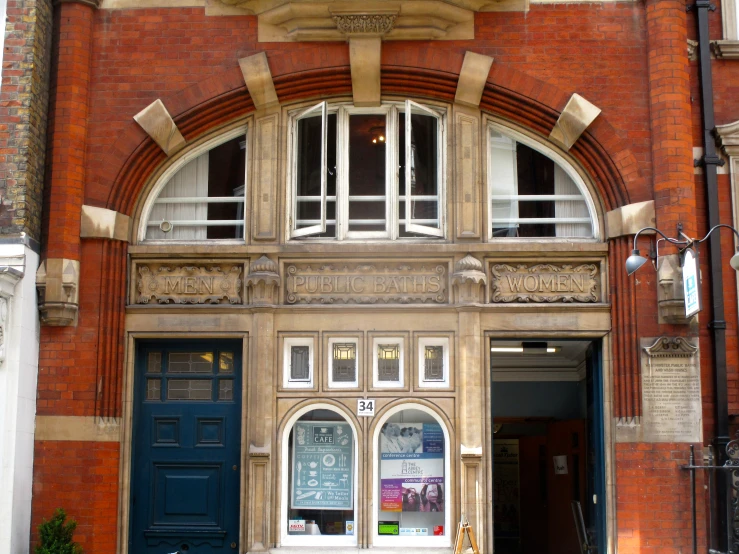 an old stone building with two blue and white doors