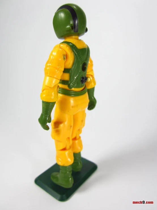 a small yellow and green figurine in space suits