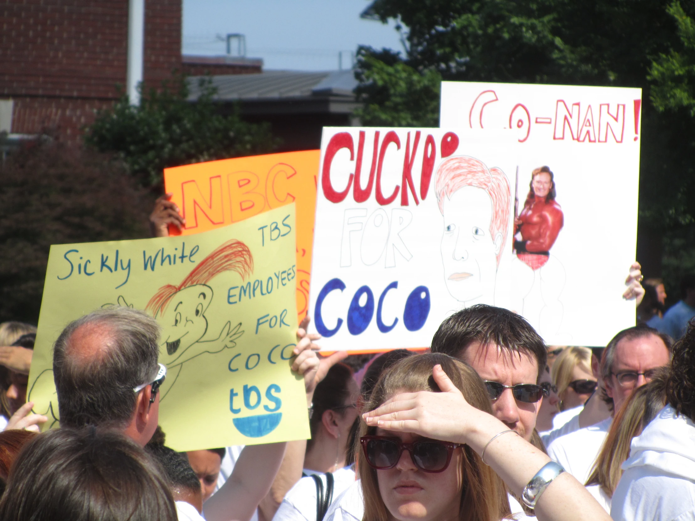 a large group of people holding signs and placards