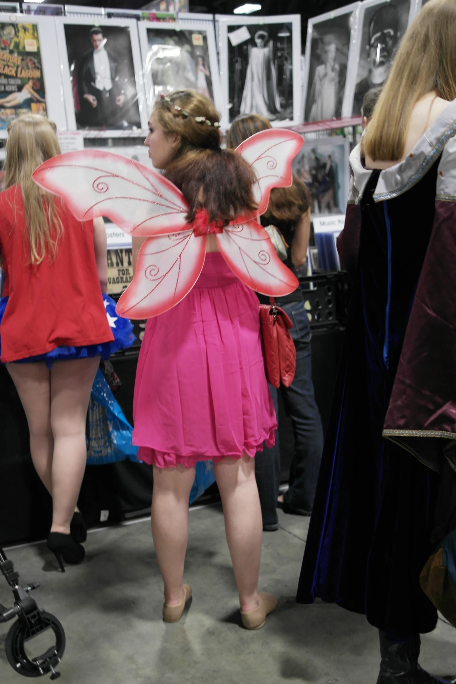 three women in costume looking at items on display