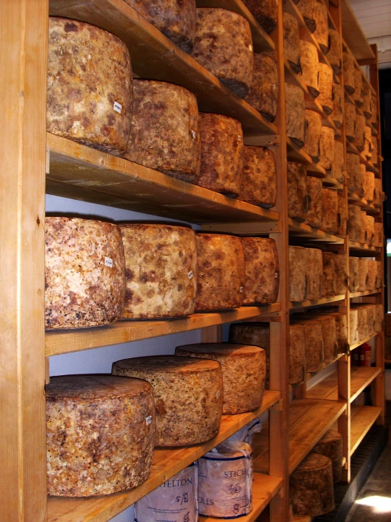 a long wood shelves holding stacks of loafs