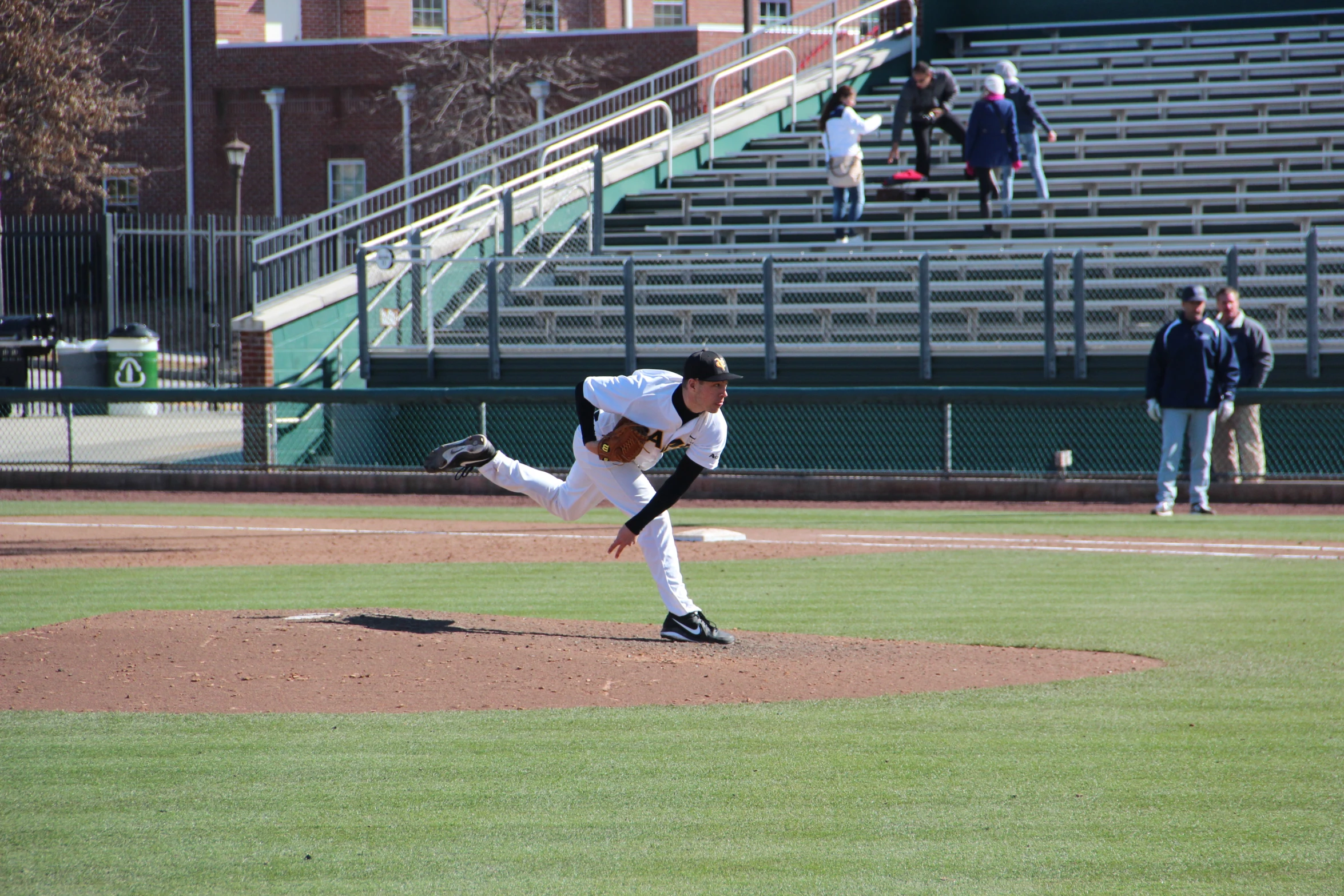 pitcher pitching baseball during game in professional baseball game