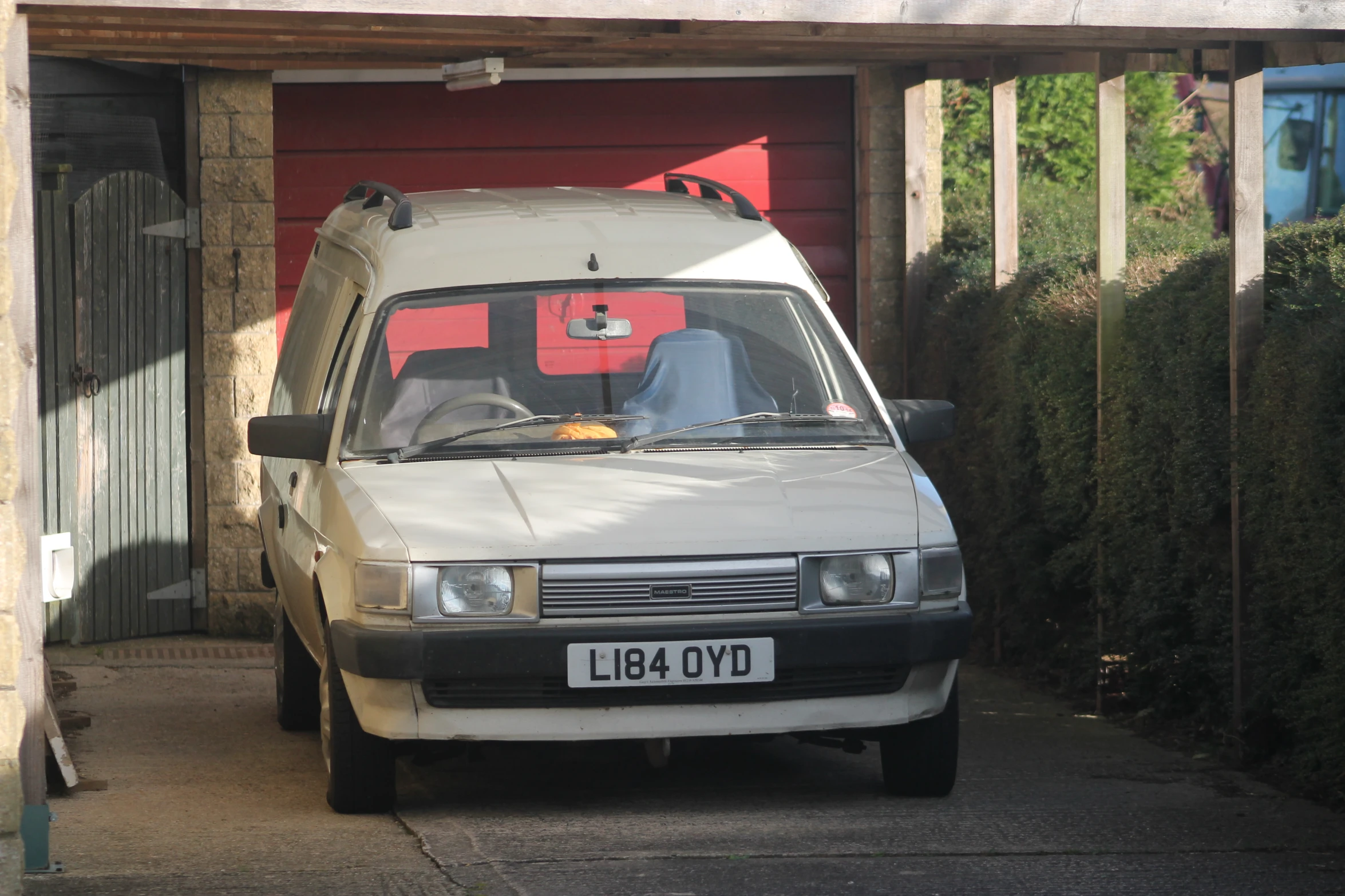 there is a car parked near a red garage