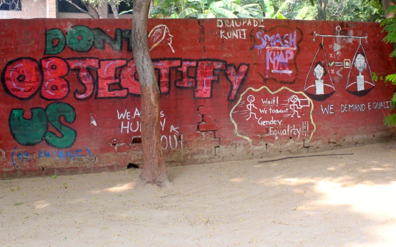 several pictures of graffiti on the wall behind a fire hydrant