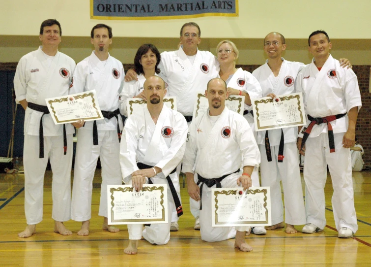 some people on a court holding plaques and smiling