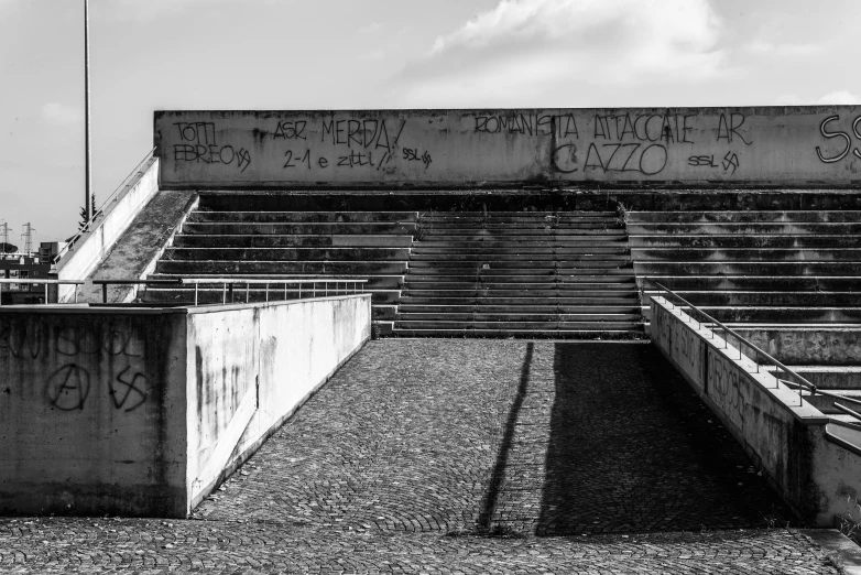 an empty bleacher covered with graffiti