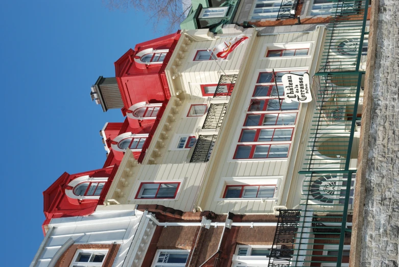 a building has a red roof with some white windows