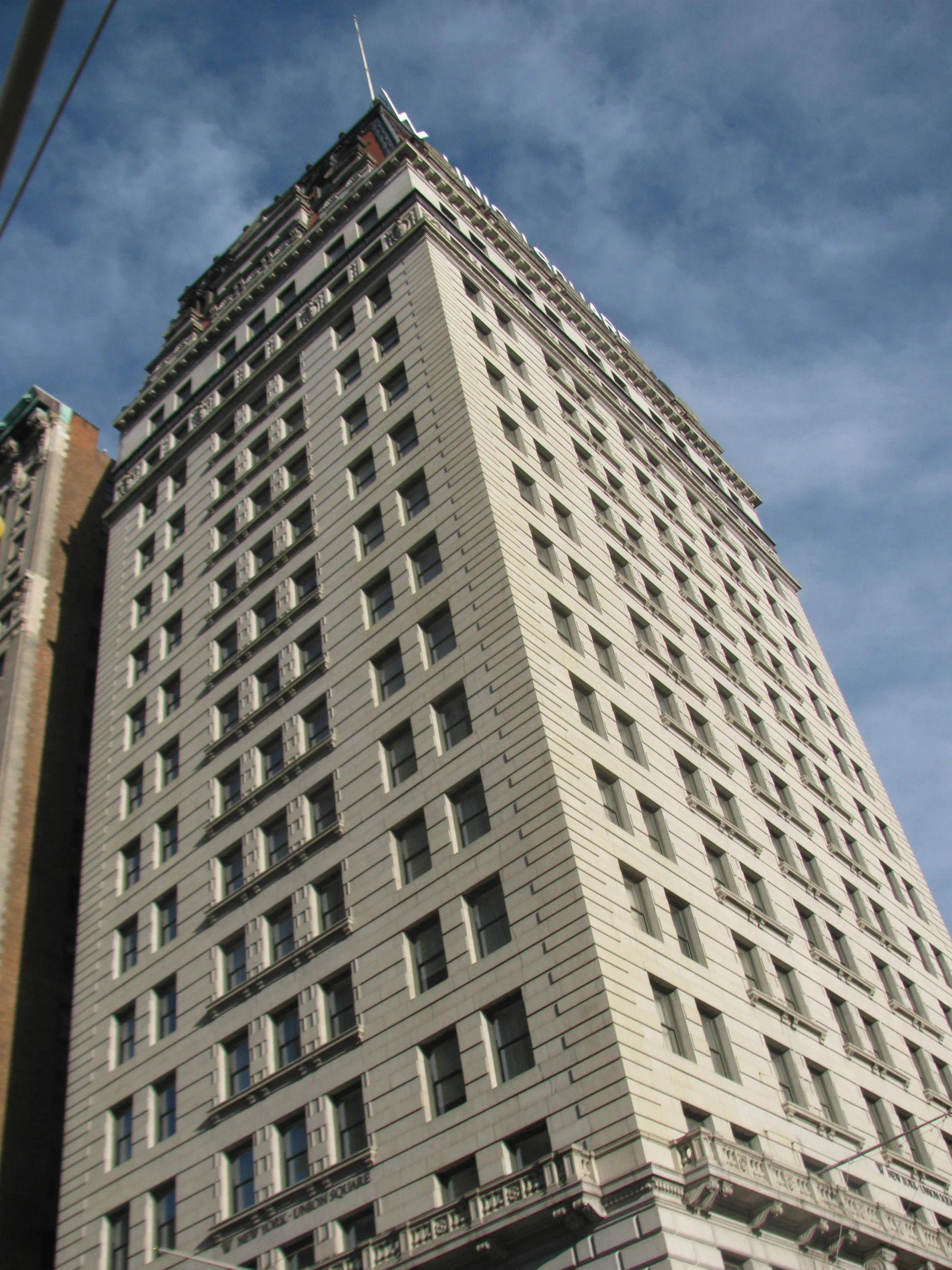 the top of an empty tall building against a blue sky