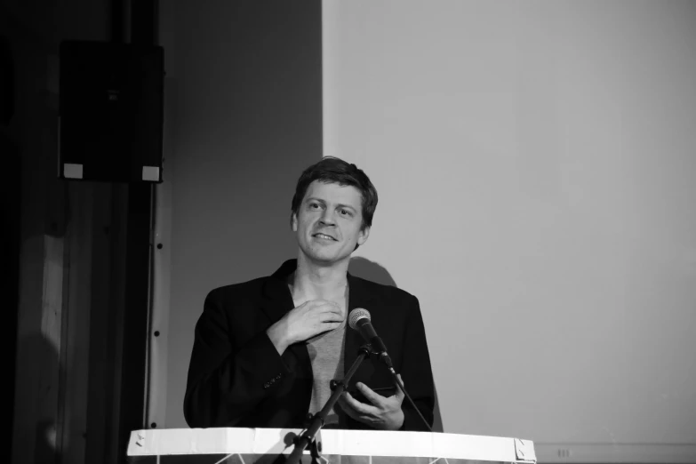 a man in a suit holding his tie to his neck