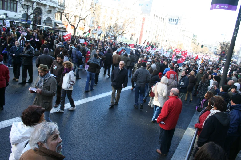 people walking down the street in protest on cold weather