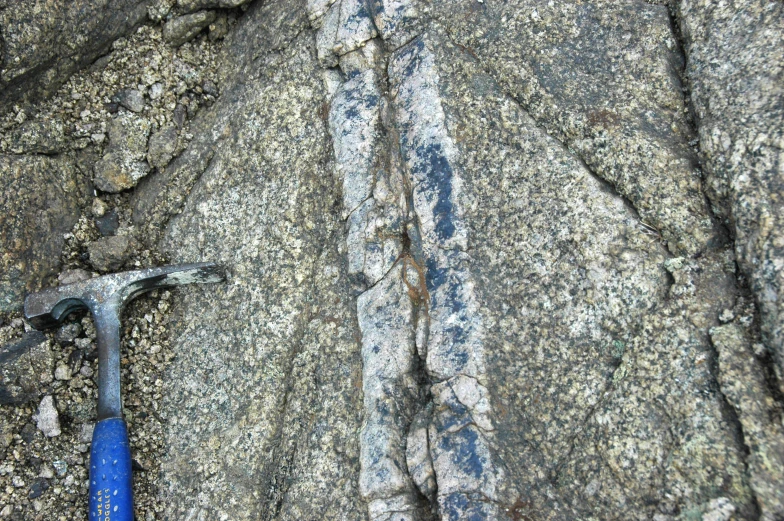 an open wrench is on top of some rocks