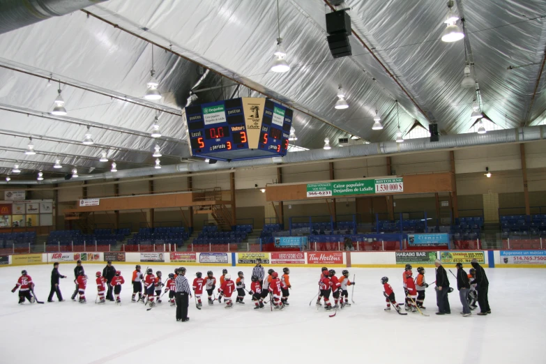 a large group of people standing on a ice rink