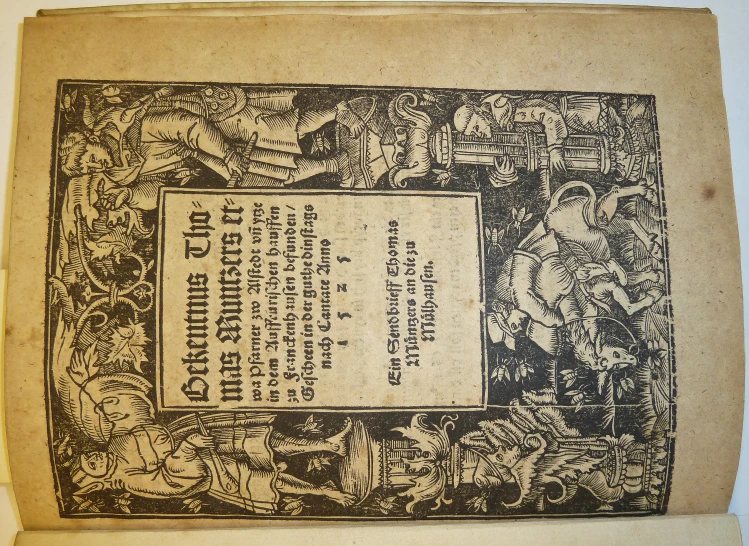 an old book opened with black and white illustration