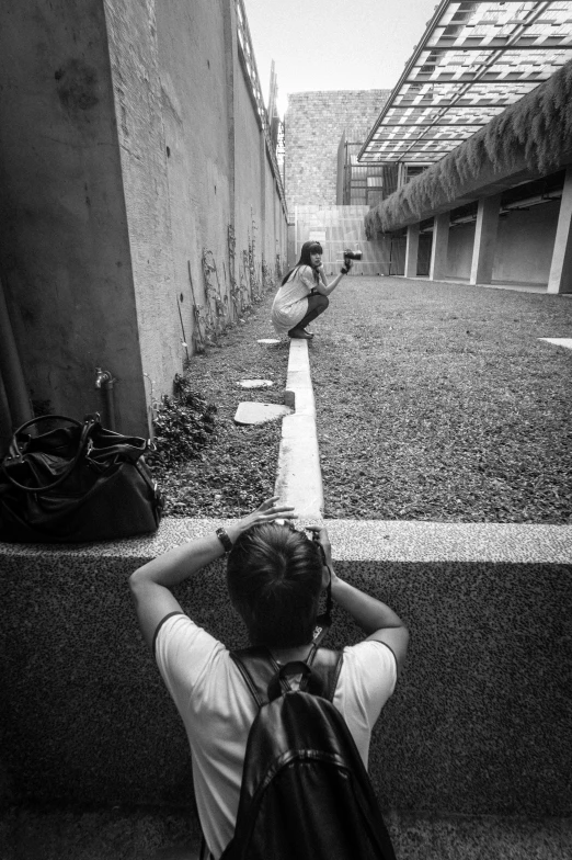 a person sitting on a bench alone on the street