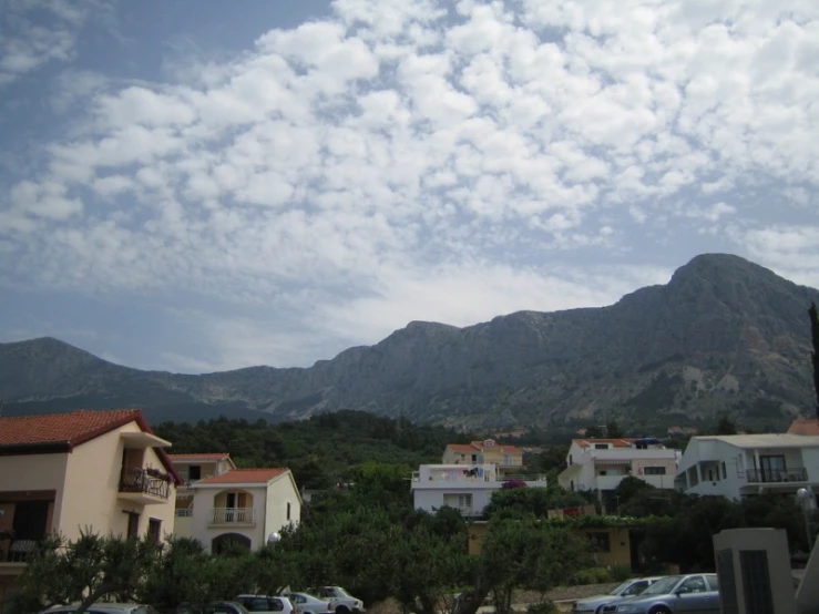 the view from a home lot in a residential area with mountains behind