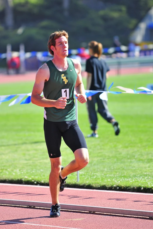 a man running on top of a field with the number five in his shirt