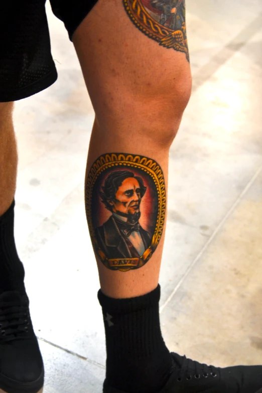 the legs of a man wearing tattoos that have a portrait of aham lincoln