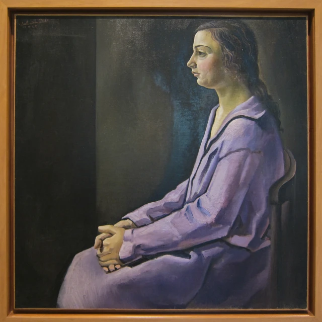 a woman with her arms crossed in prayer, with the picture of her seated next to her