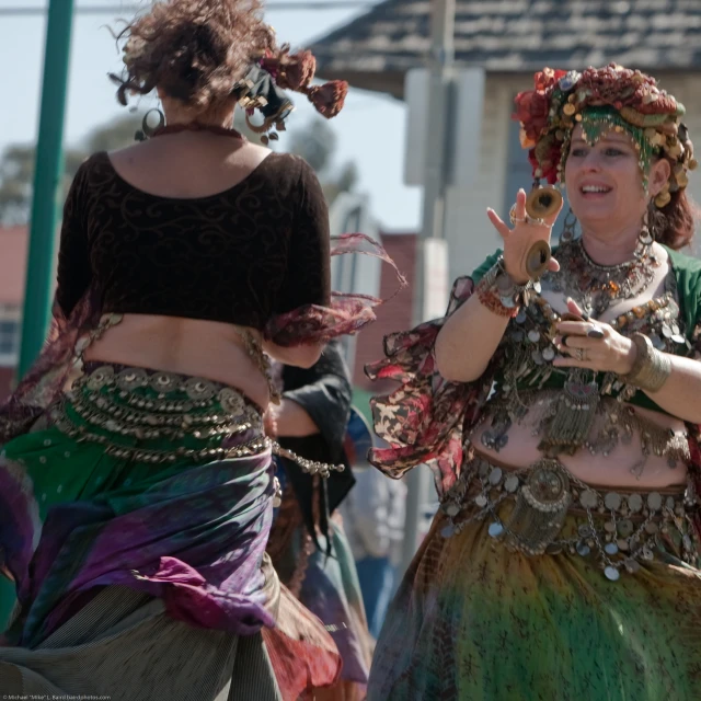 two women in elaborate clothes dance with each other