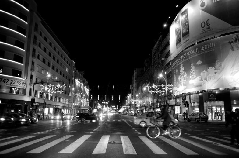 a bike and car driving down a street at night