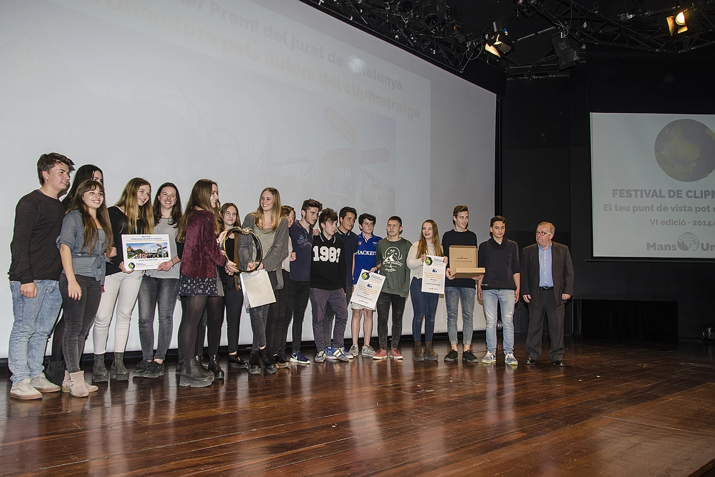 the people are standing on a stage with a plaque