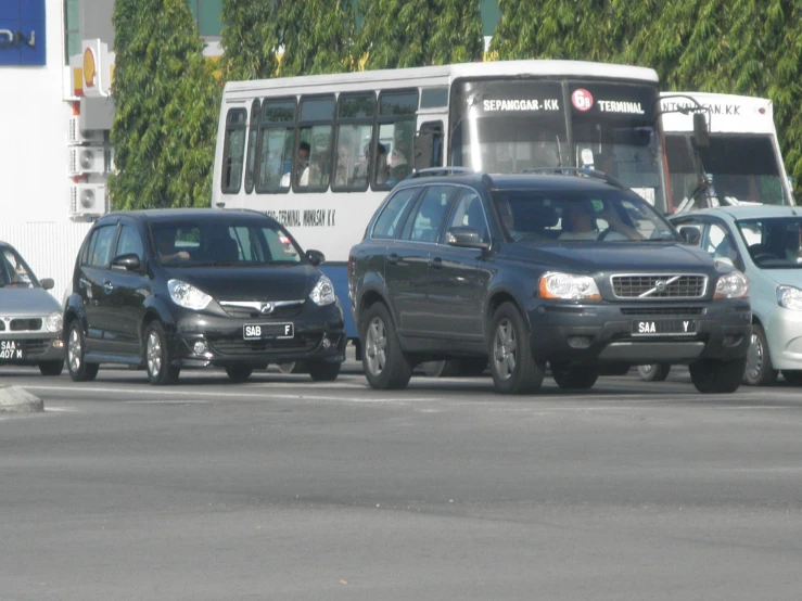 cars and buses on the road with a double decker bus