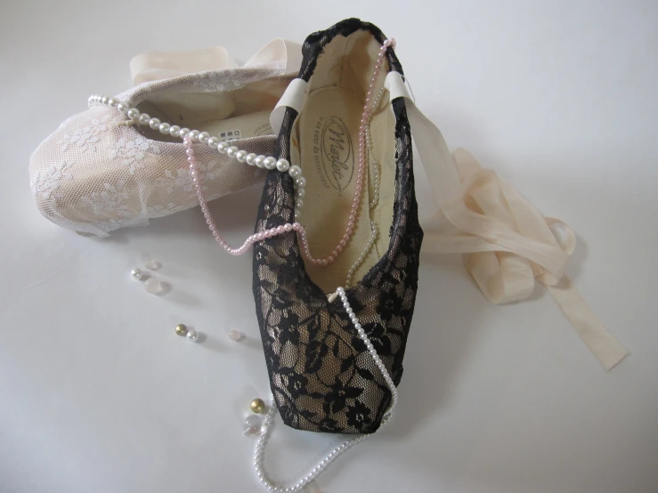 two shoes with pearls and pearls hanging from them