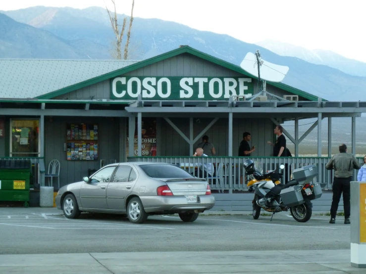 a store with two cars parked in front of it