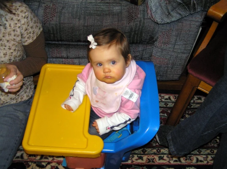 a young baby sitting in a play table