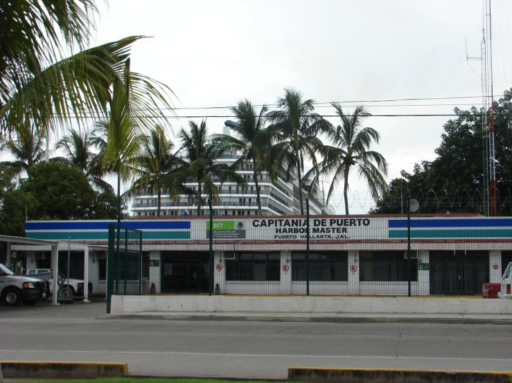a car is parked at a gas station in a tropical setting