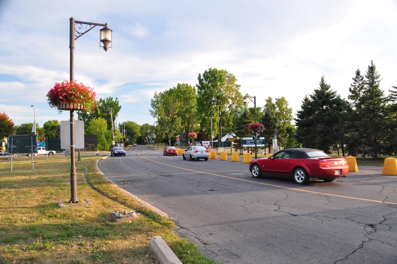 cars traveling around an empty intersection at a stop light