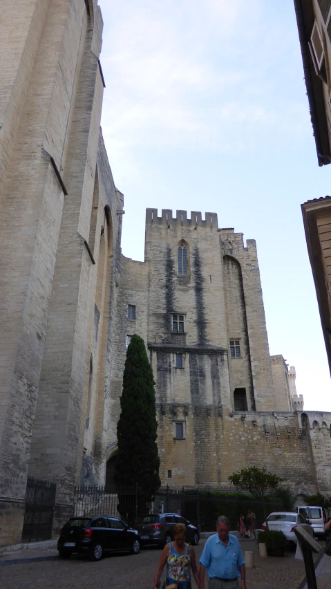 a man and a woman standing next to a castle