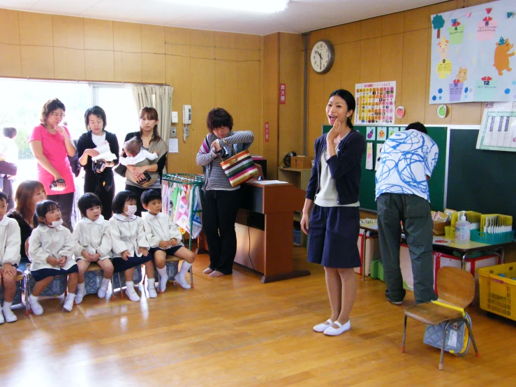 a  singing a song in front of school children