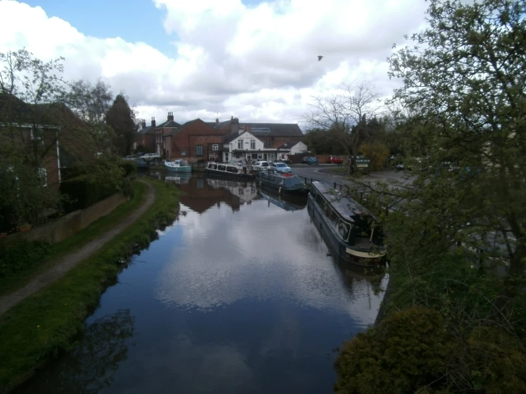 boats are sitting at a waterway on the water