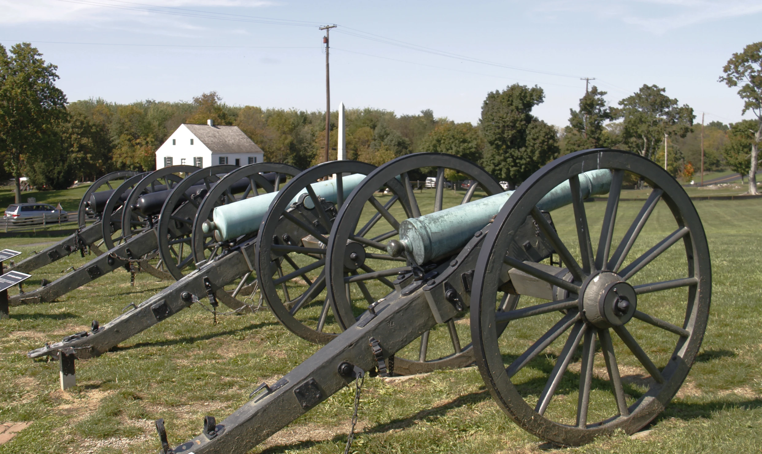 a row of artillery wheels next to each other