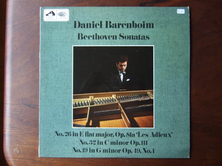 a cover for a musical album with a man playing an organ