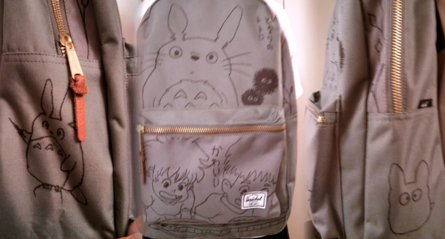 the zipper is open to reveal a backpack with drawings on it