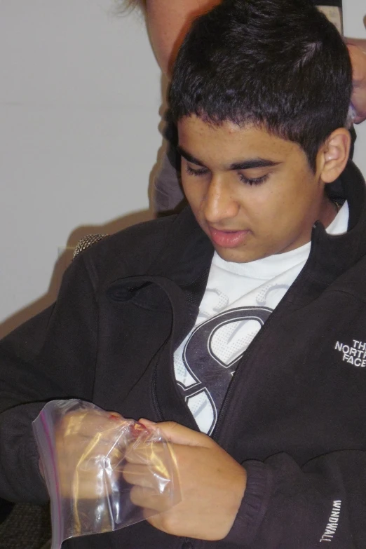 a young man examines the contents of a package