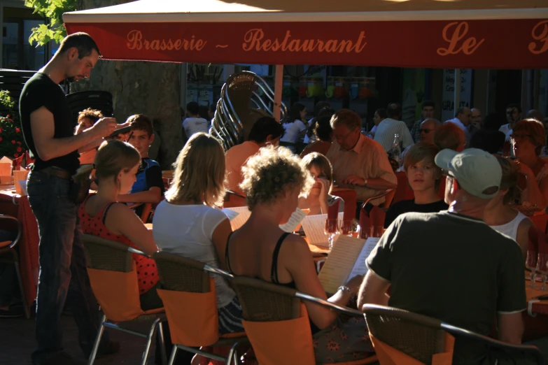 a restaurant with a man holding an umbrella above it