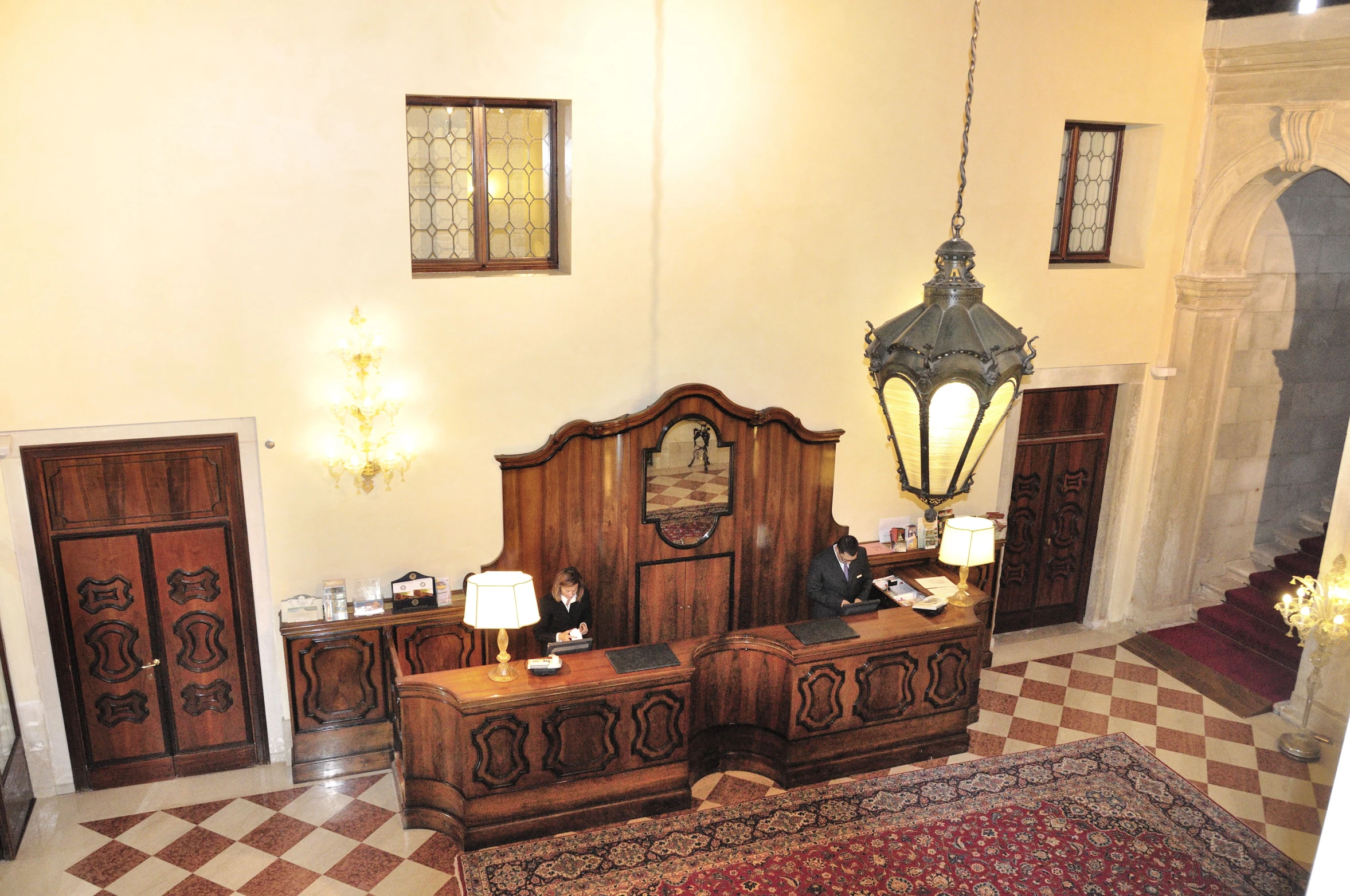 a room with a bunch of wooden furniture and hanging lights